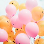 Balloons with happy and sad faces on them